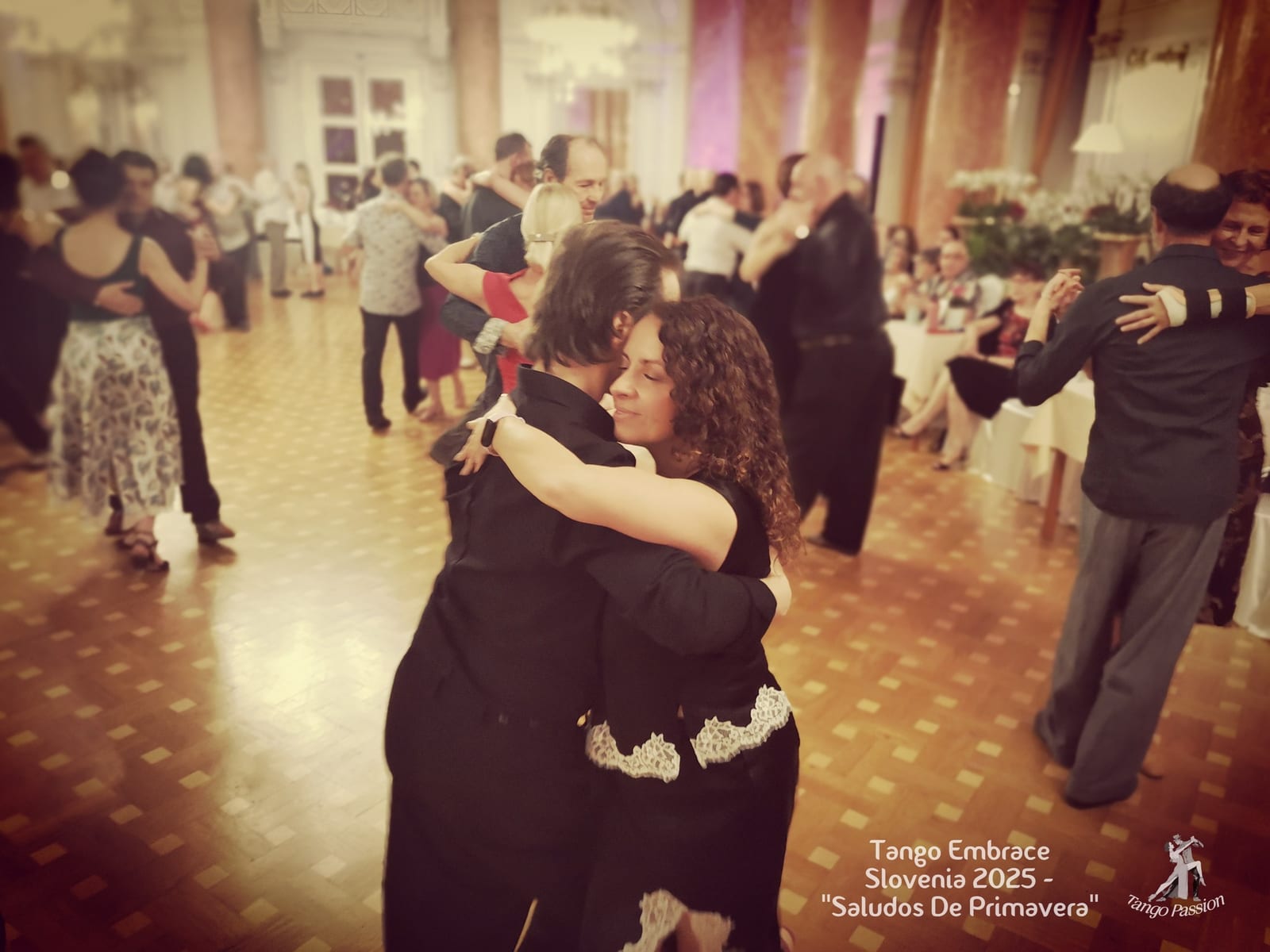Couple dancing in a close embrace at a milonga